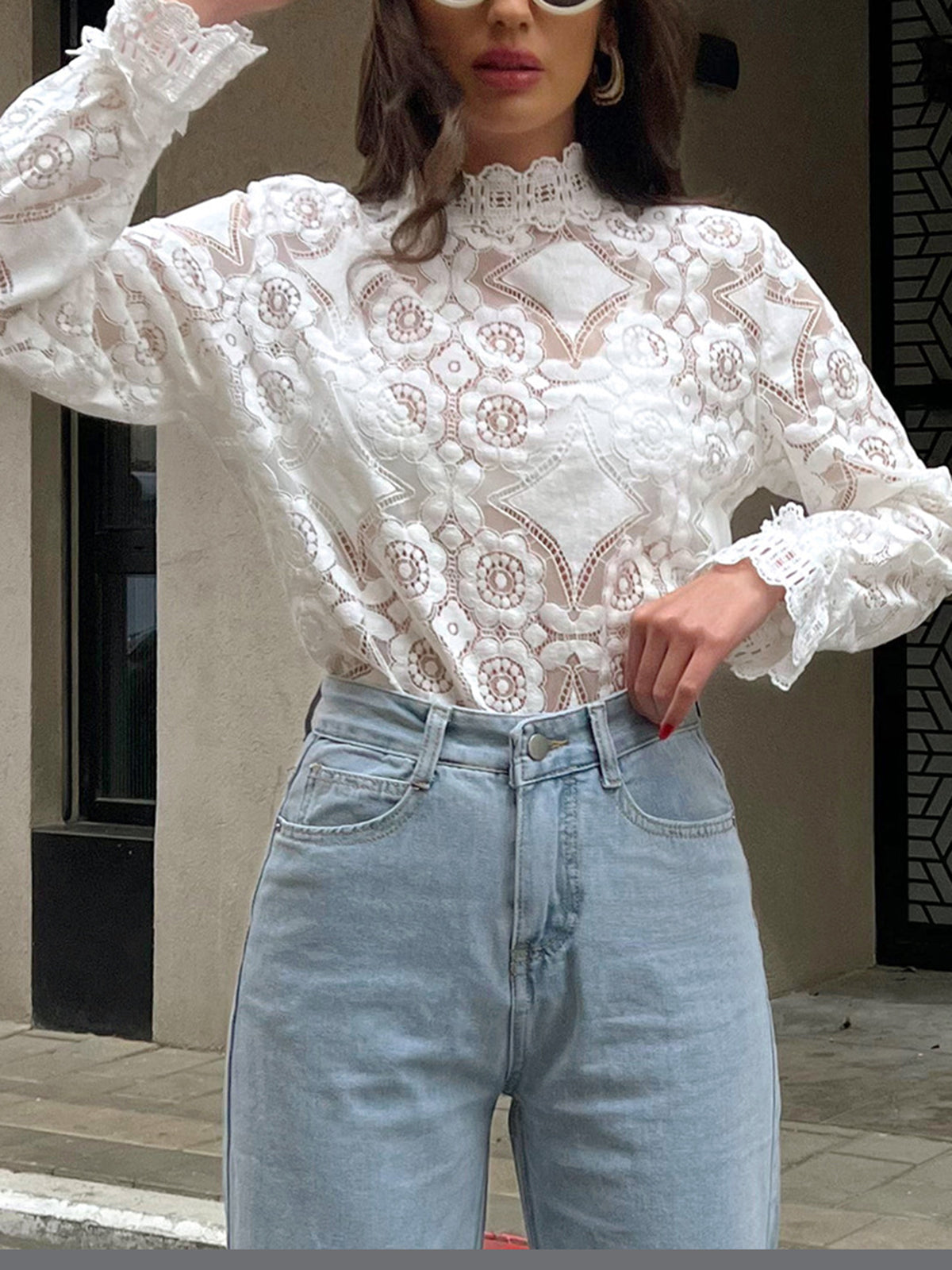 Blouse with a high collar made of embroidered lace