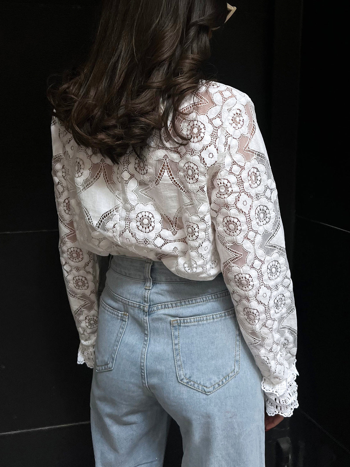 Blouse with a high collar made of embroidered lace