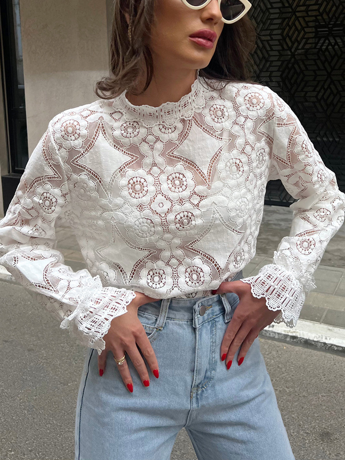 Blouse with a high collar made of embroidered lace