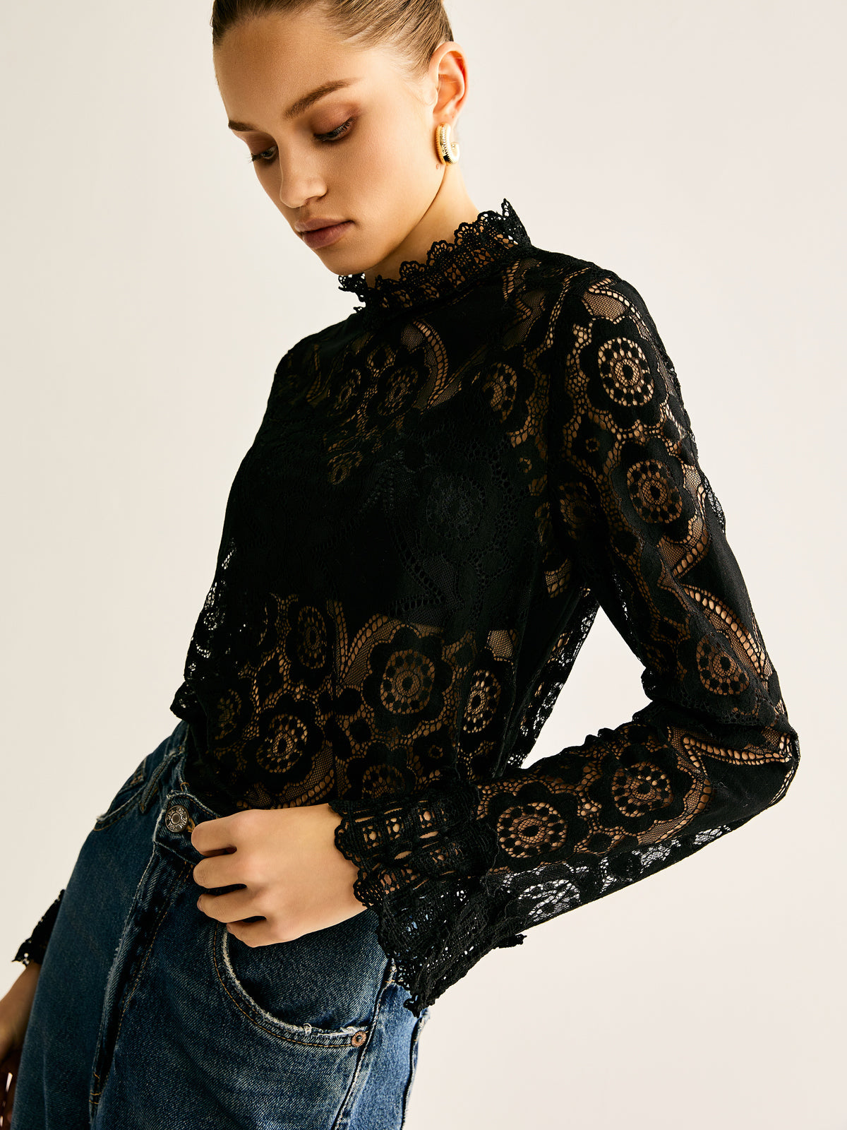 Blouse with a high collar made of embroidered lace